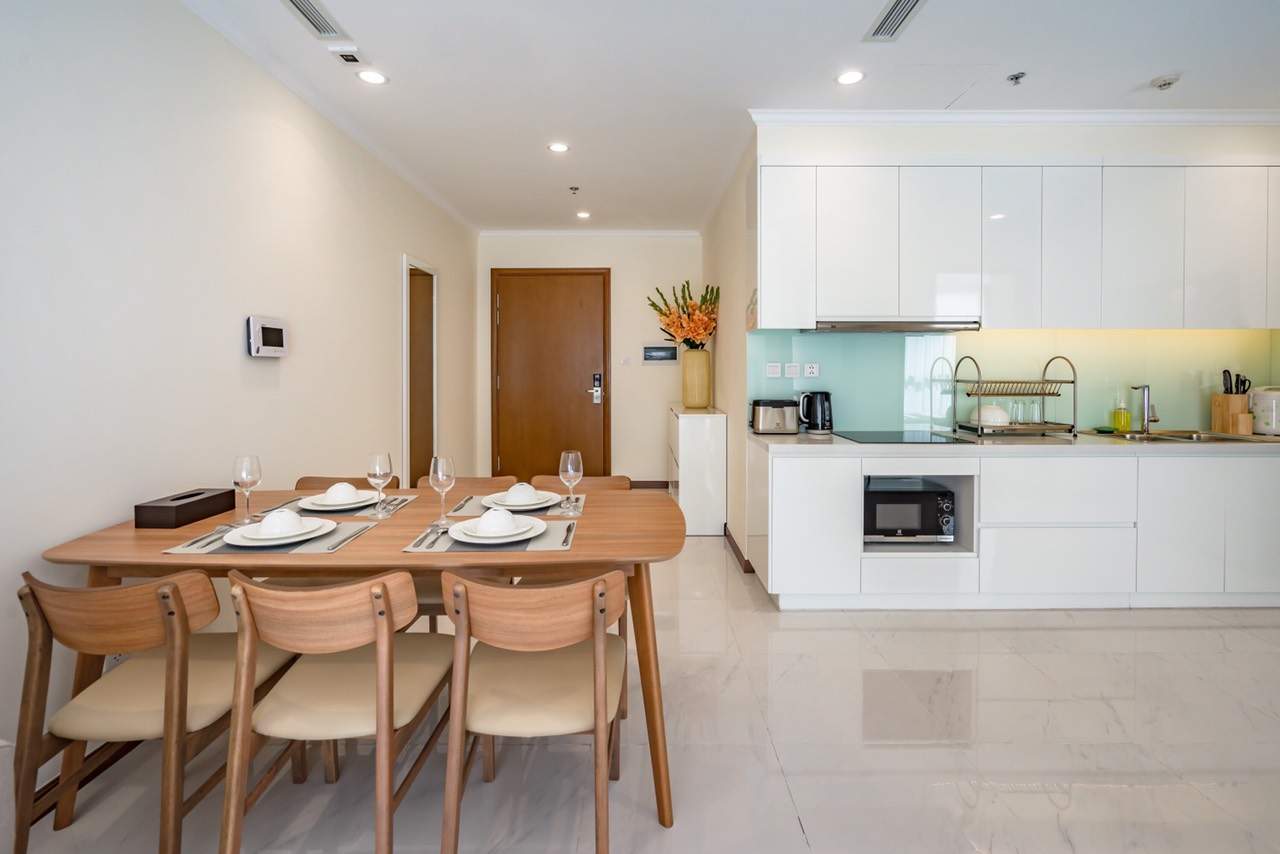 The wooden dining set in the rare and unique apartment in vinhomes central park apartment for rent with 3 bedrooms